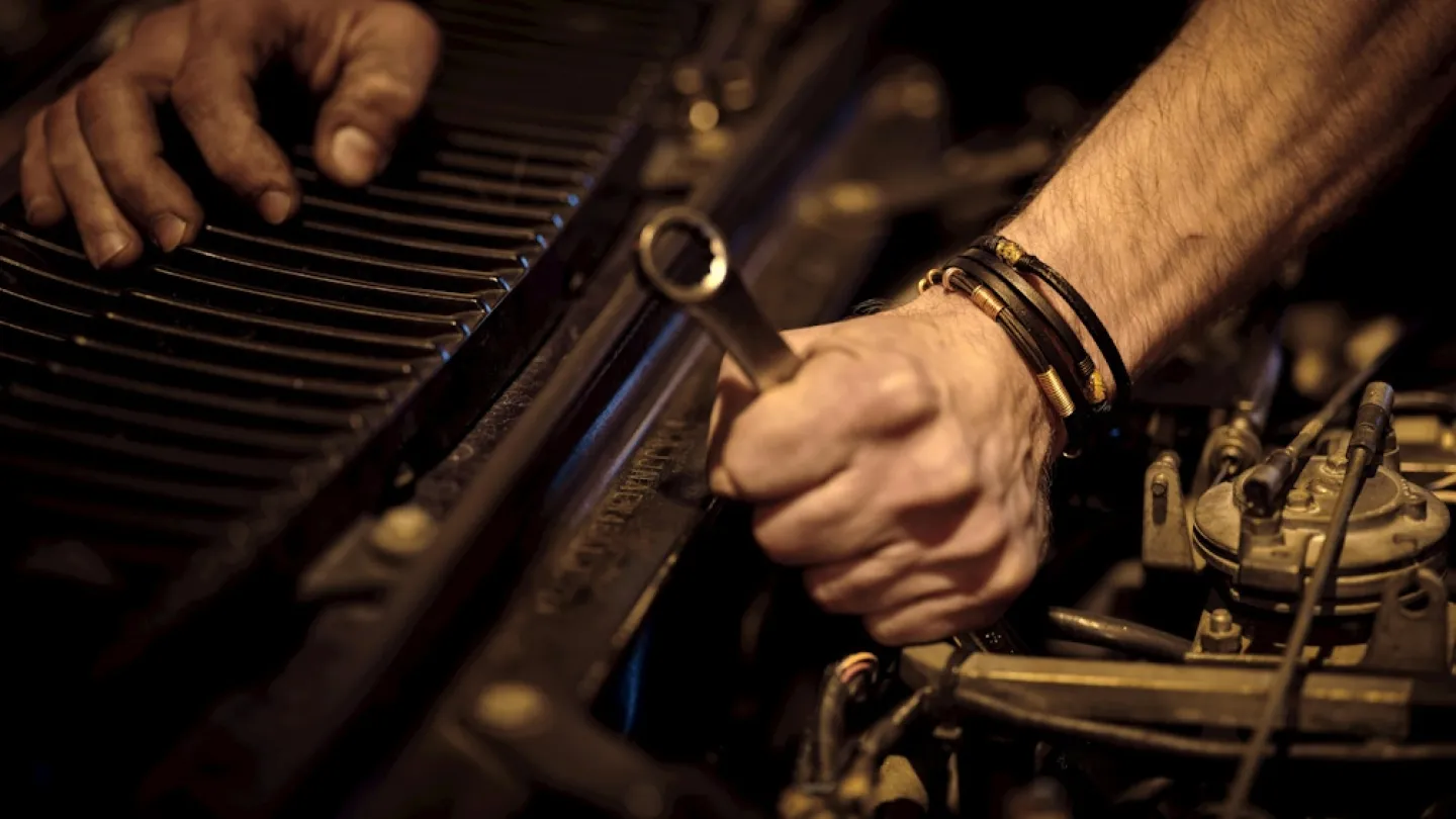 Close-up of a mechanic remanufacturing a diesel engine.